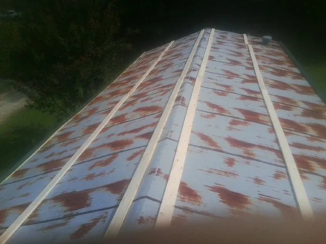 Rusted metal roof panels with new wood purlins before replacement — Storm Damage Roof Repair in Smoketown by Roofing Brothers