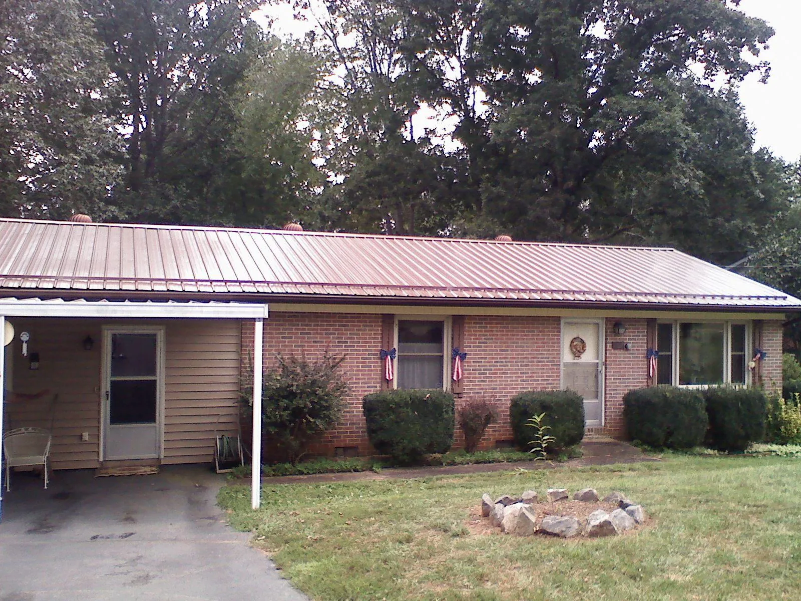 Bronze metal roof and carport on a brick ranch home — Roof Repair work by our crew in Smoketown