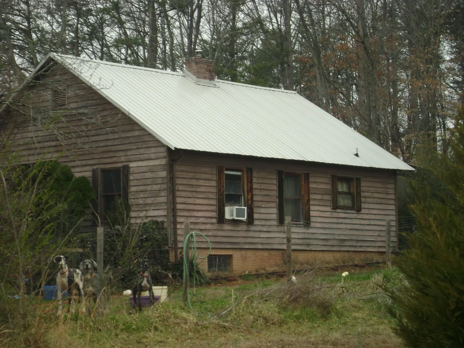 White metal roof on an old wood sided farmhouse, from a Metal Roof Installation job in Smoketown